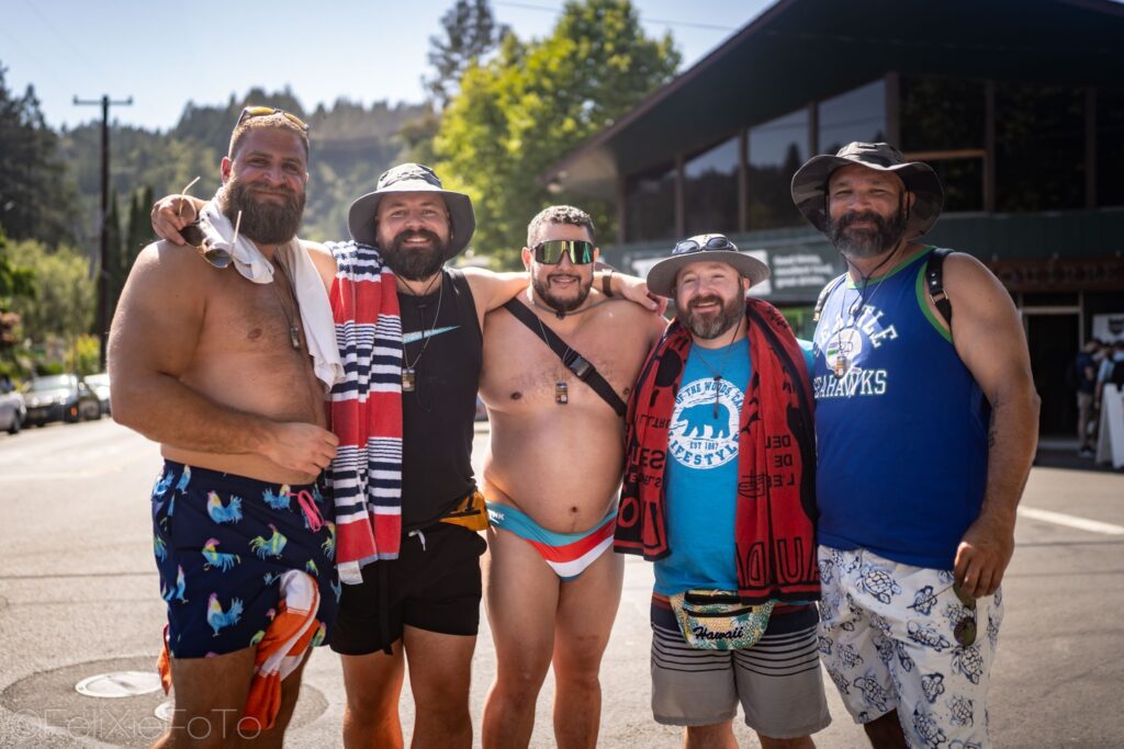 A crowd of Lazy Bear Week attendees gathered at a poolside event in Guerneville